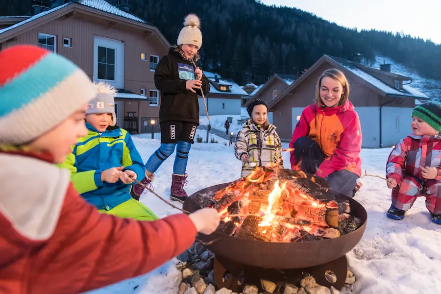 Après-ski met je kinderen bij Landal Bad Kleinkirchheim: marshmellows maken. Op dit vakantiepark is een bar waar regelmatig na het skiën geborreld wordt. © Landal